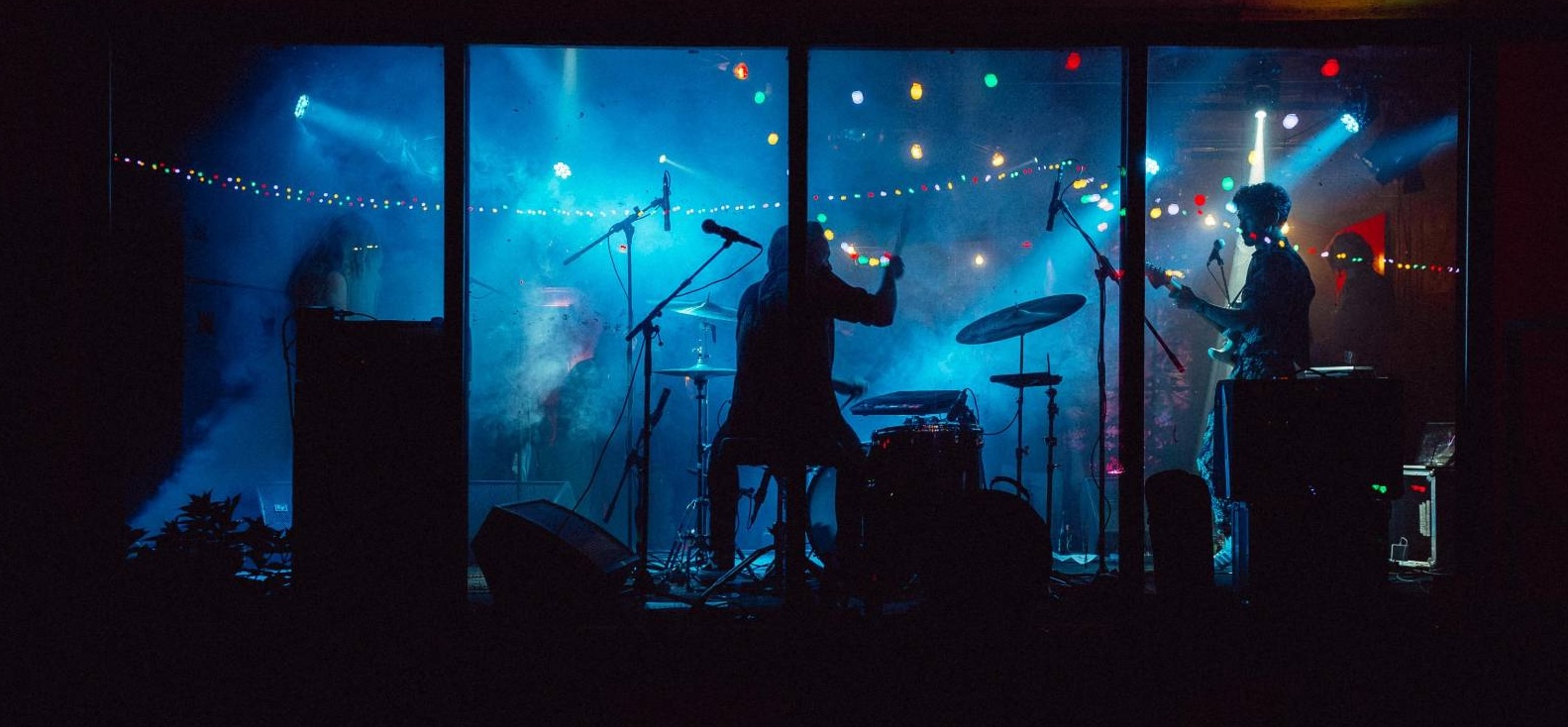 Band playing behind foggy glass.