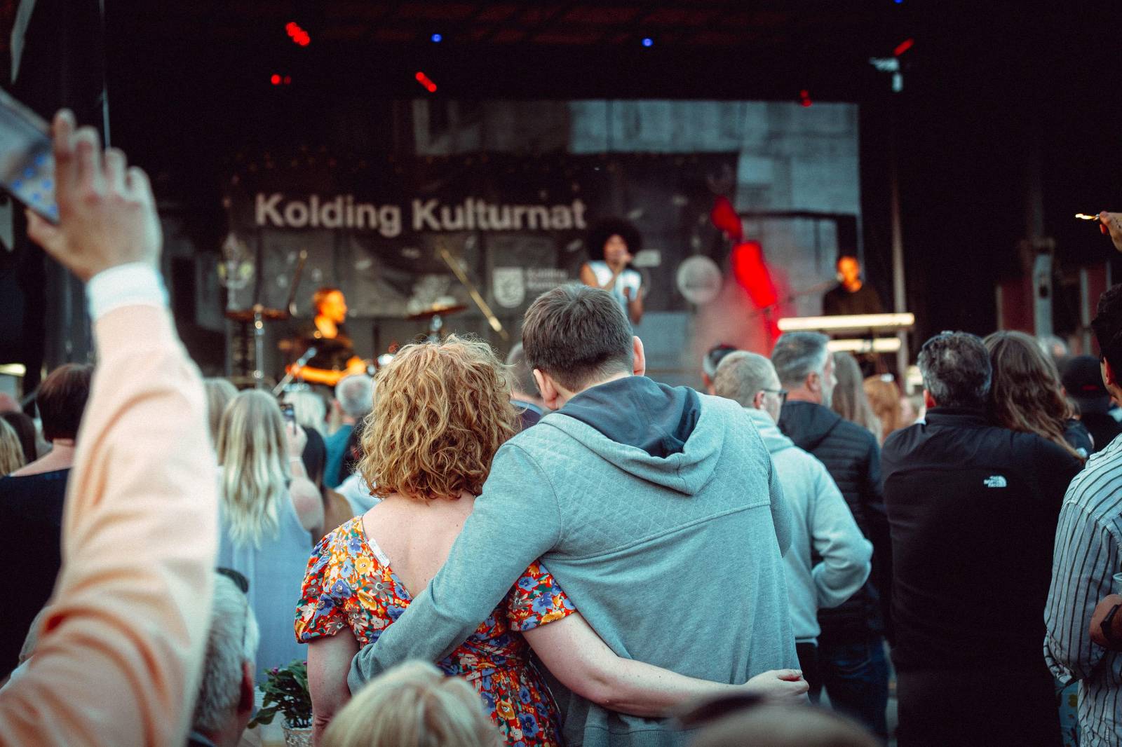 Couple listening to stage performance.